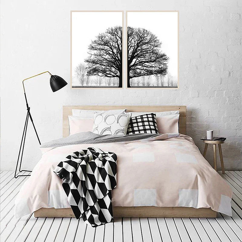 Modern bedroom with minimalist decor, black and white tree art, and geometric bedding