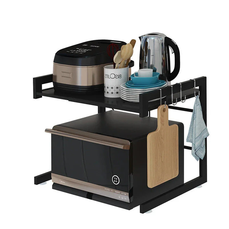 Black kitchen appliance stand with microwave, rice cooker, kettle, and hanging utensils for organized countertop storage