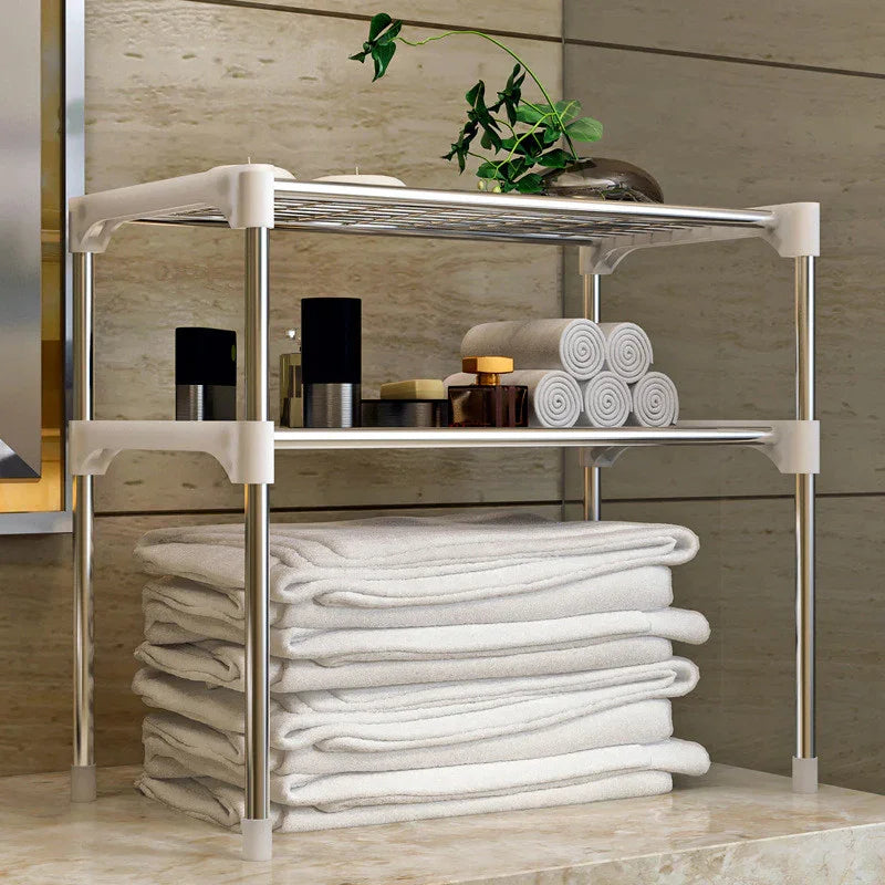 Stainless steel bathroom shelf with towels, toiletries, and plant, ideal for bathroom organization and storage