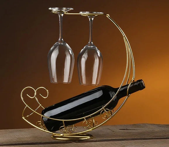 Elegant gold wine bottle holder with two hanging glasses, perfect for home or bar decor