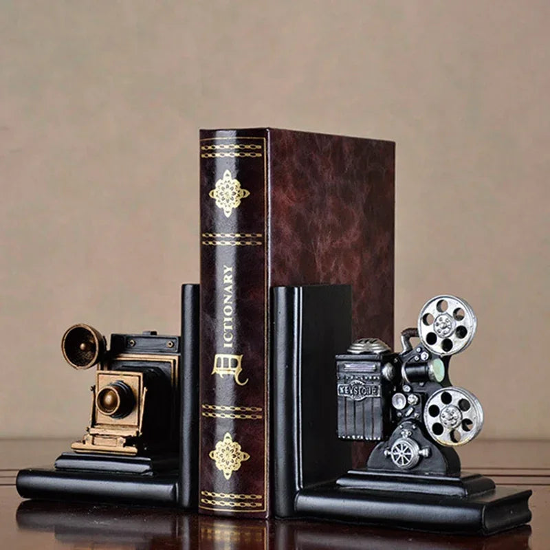 Vintage camera and film projector bookends holding a dictionary, classic home decor
