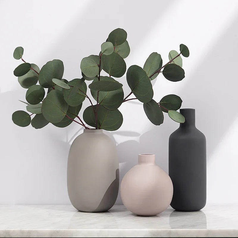 Modern ceramic vases with eucalyptus branches, minimalist home decor for living room or office