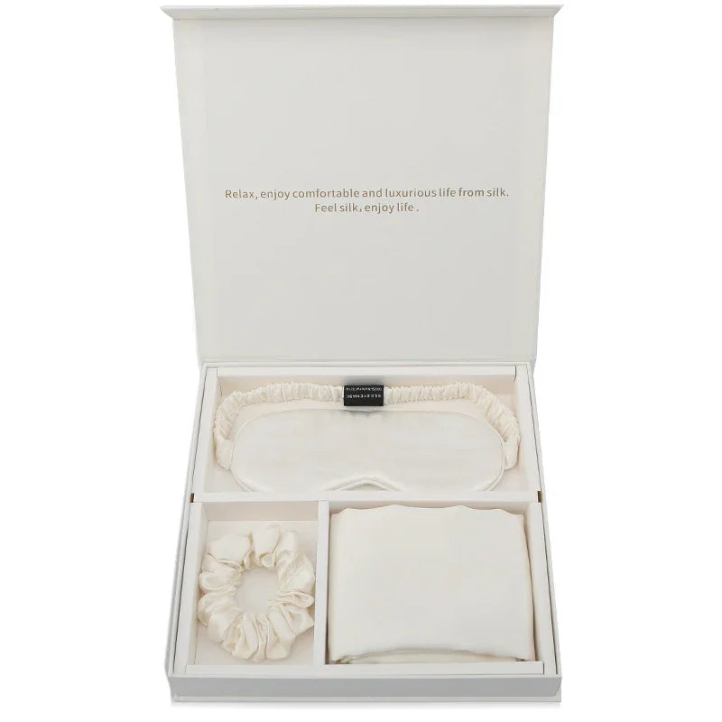 Luxury silk gift set with ivory sleep mask, scrunchie, and pillowcase in a white box