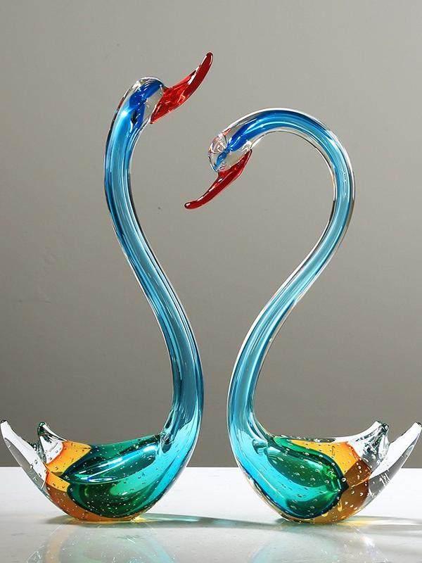 Colorful glass swan figurines with blue, green, and red accents, elegant home decor pieces
