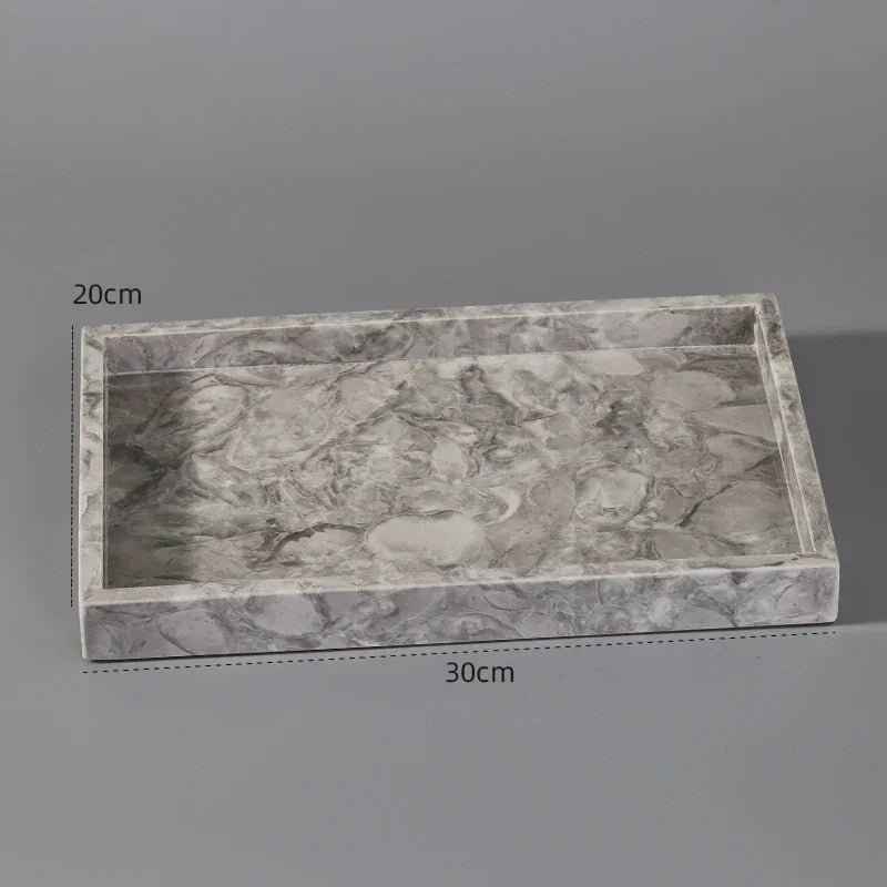 Rectangular grey marble tray with raised edges, 30cm by 20cm, on grey background