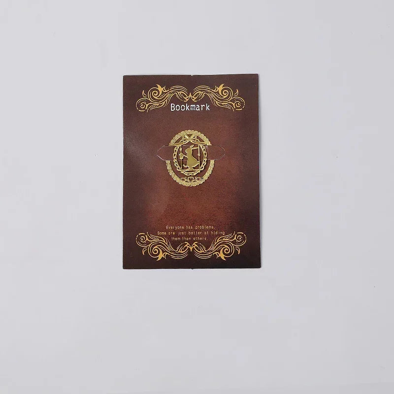 Elegant brown leather bookmark with gold emblem and decorative swirls, featuring inspirational quote.