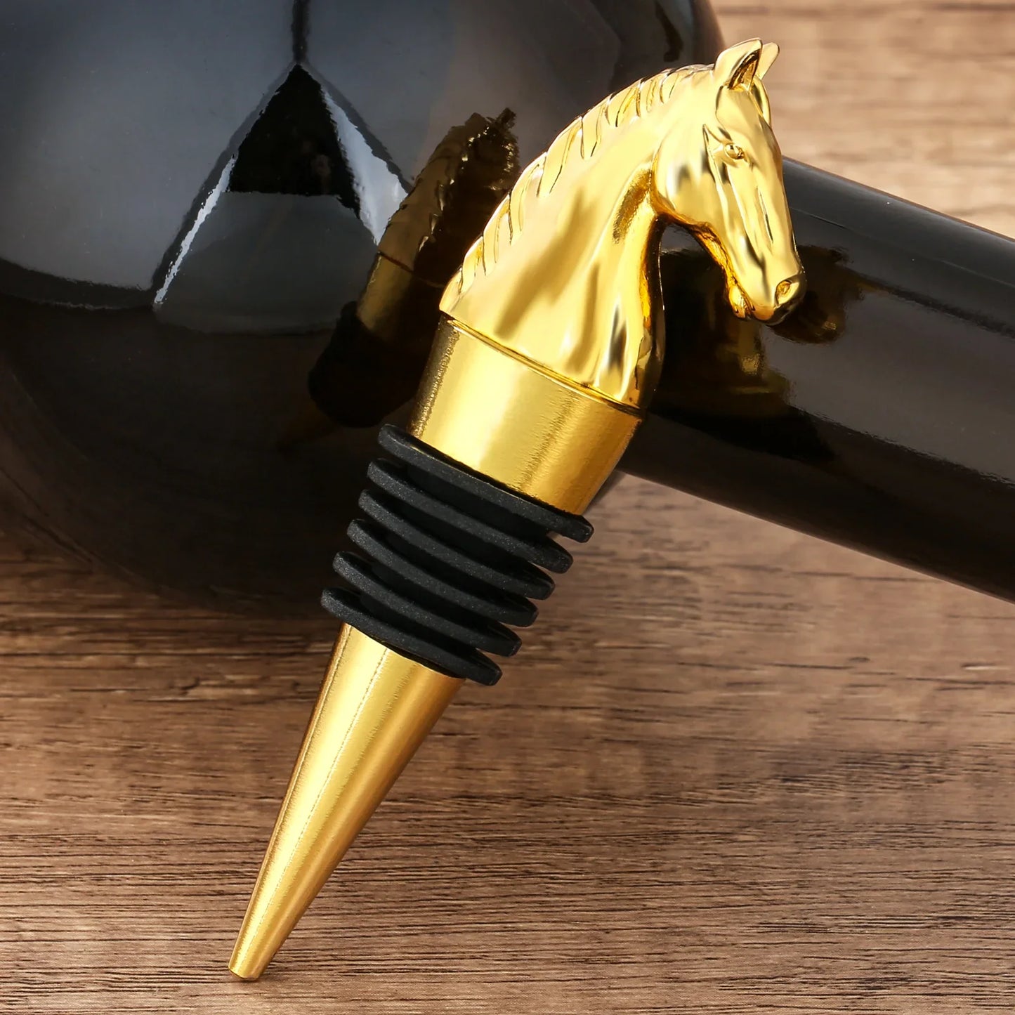 Golden horse head wine stopper with black rubber seal, elegant bottle accessory on wood