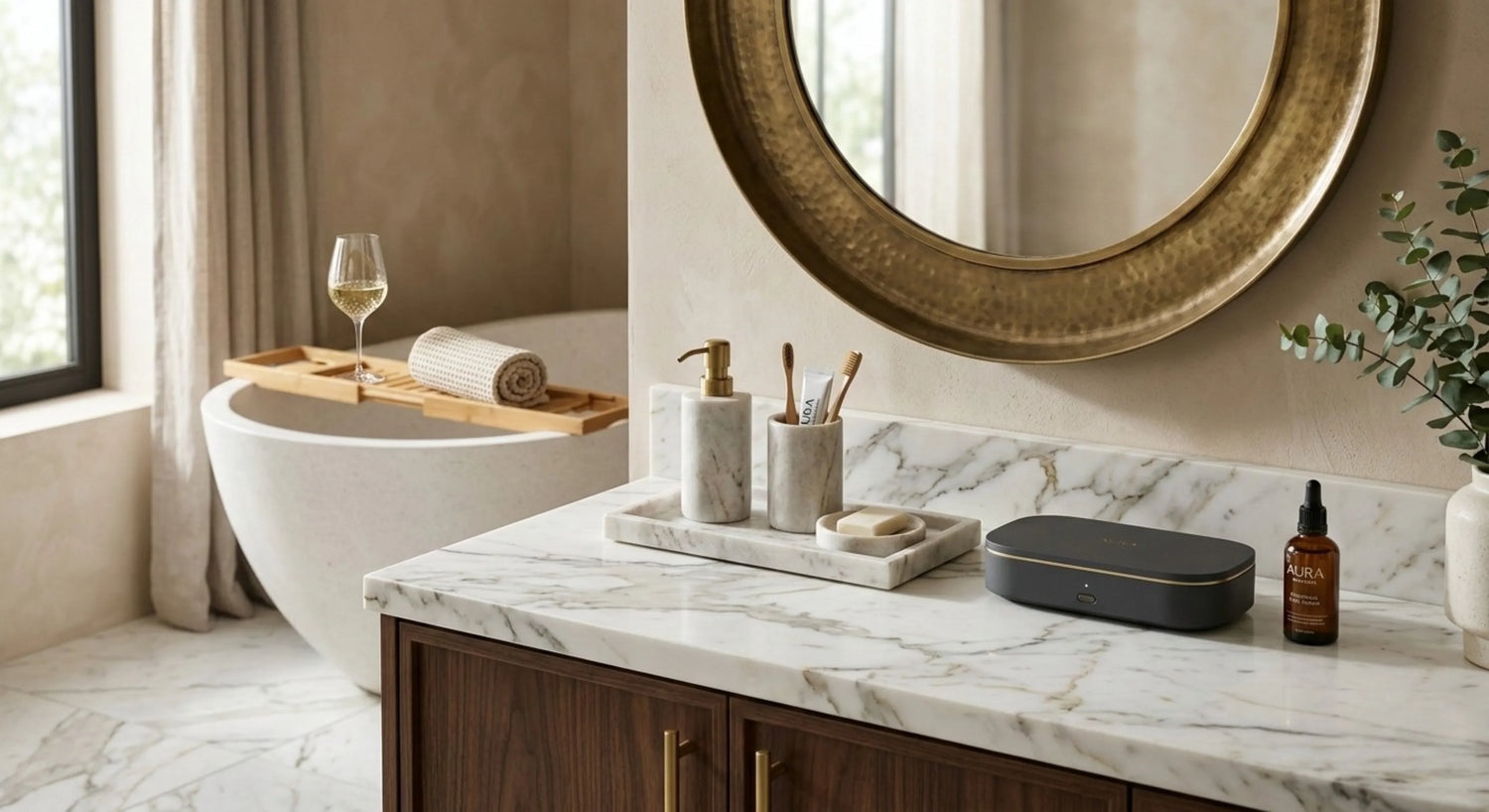 Luxury bathroom with marble vanity, round gold mirror, bathtub and spa accessories