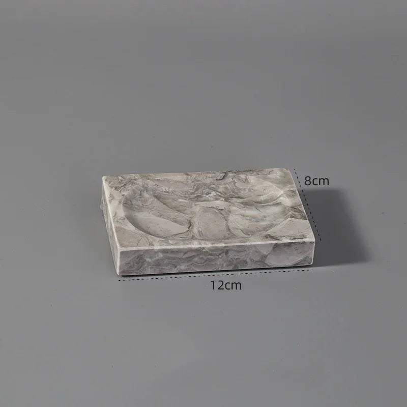 Rectangular marble-patterned tray with rounded indents, 12cm by 8cm, on grey background