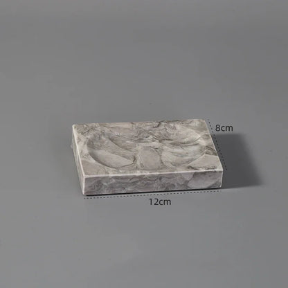 Rectangular marble-patterned tray with rounded indents, 12cm by 8cm, on grey background
