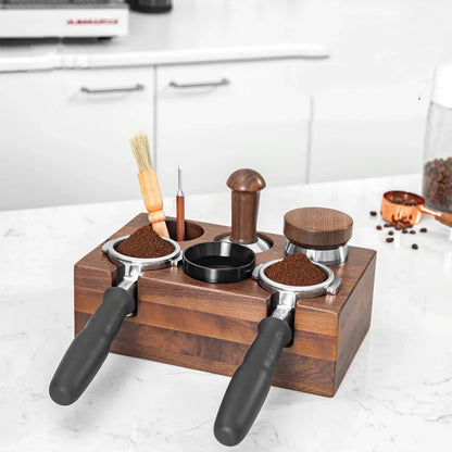 Espresso coffee accessories set with wooden organizer, tampers, portafilter handles, and a brush on kitchen counter