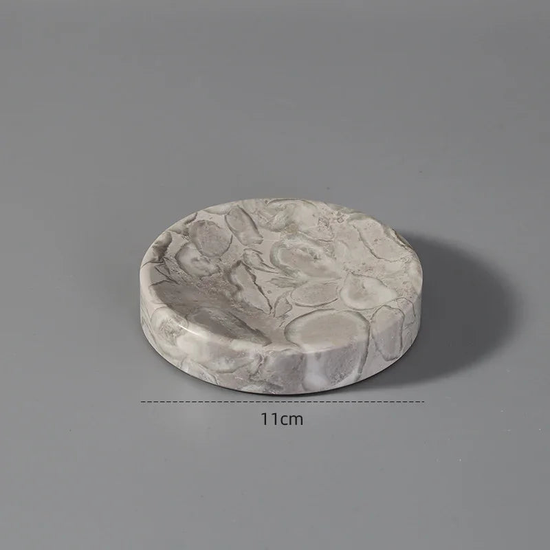 Round marble-patterned stone coaster, 11cm diameter, on gray background