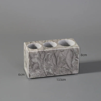 Rectangular marble pen holder with three round slots, 13.5x6x8cm, on gray background