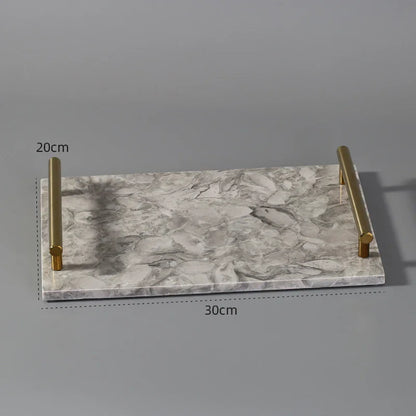 Rectangular marble serving tray with gold metal handles, 30cm by 20cm.