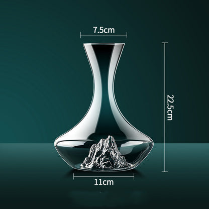 Elegant glass decanter with mountain design, 22.5cm tall, 11cm base, 7.5cm neck opening.