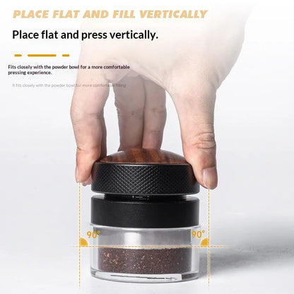 Hand pressing coffee tamper with wooden handle onto ground coffee in a clear container