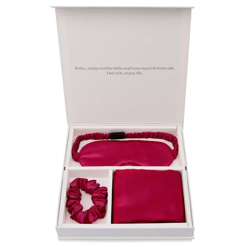 Silk gift set with pink sleep mask, pillowcase, and scrunchie in white box