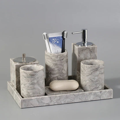 Marble bathroom accessories set with toothbrush holder, soap dispenser, cups, and tray