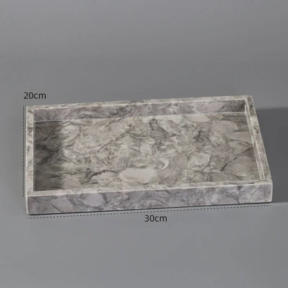 Rectangular grey marble tray with raised edges, 30cm by 20cm, on grey background