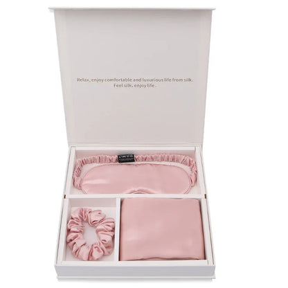 Pink silk gift set with sleep mask, scrunchie, and pillowcase in white box
