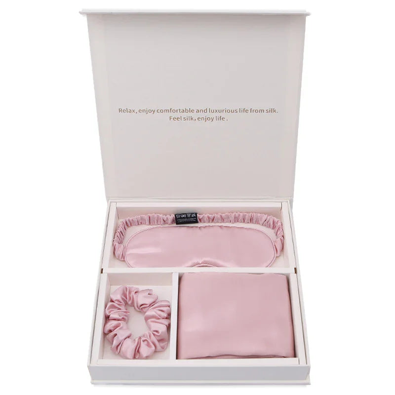 Pink silk sleep mask, scrunchie, and pillowcase gift set in white box