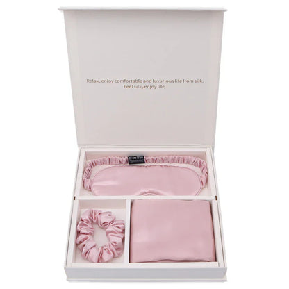 Pink silk sleep mask, scrunchie, and pillowcase gift set in white box