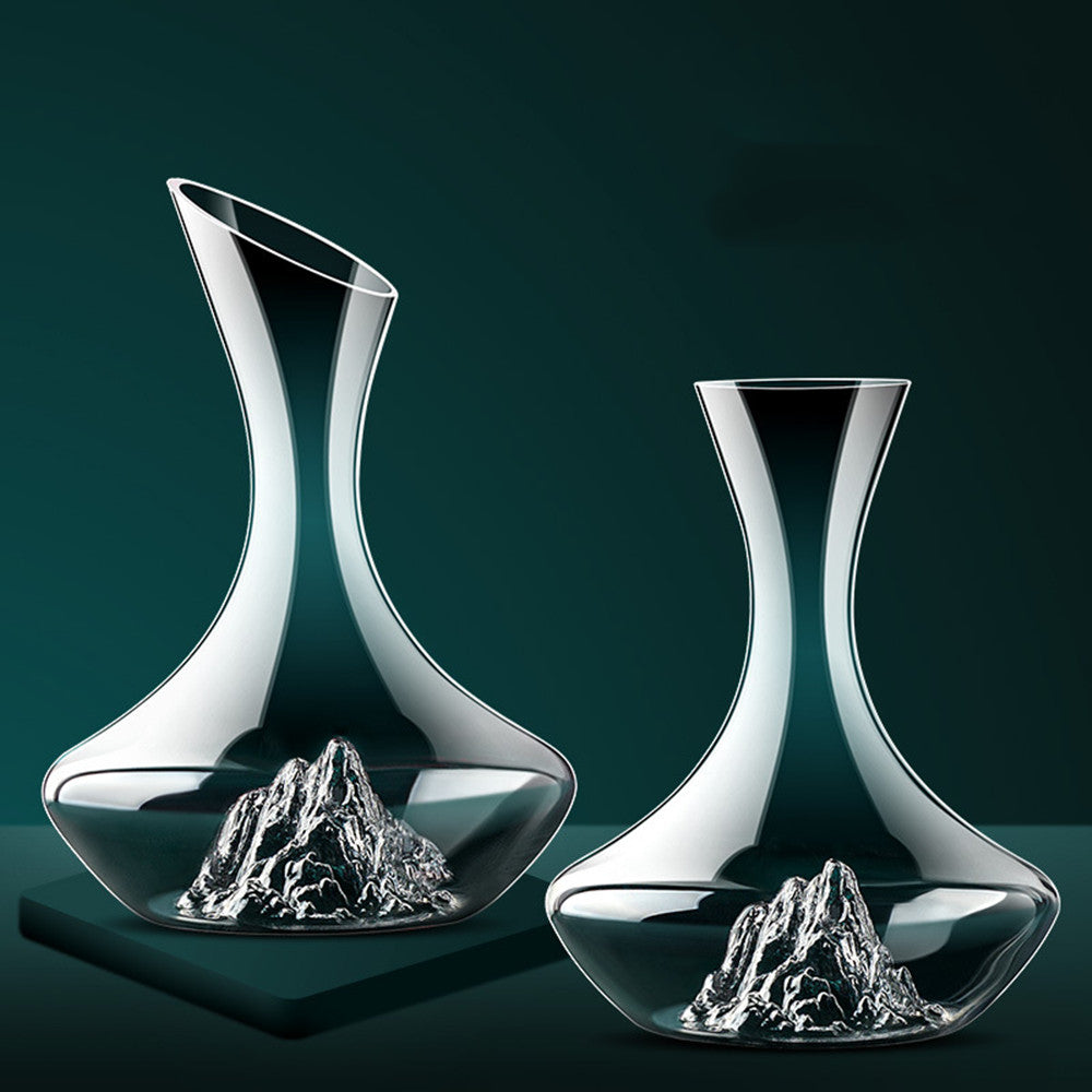 Elegant glass decanters with mountain design base on dark green background