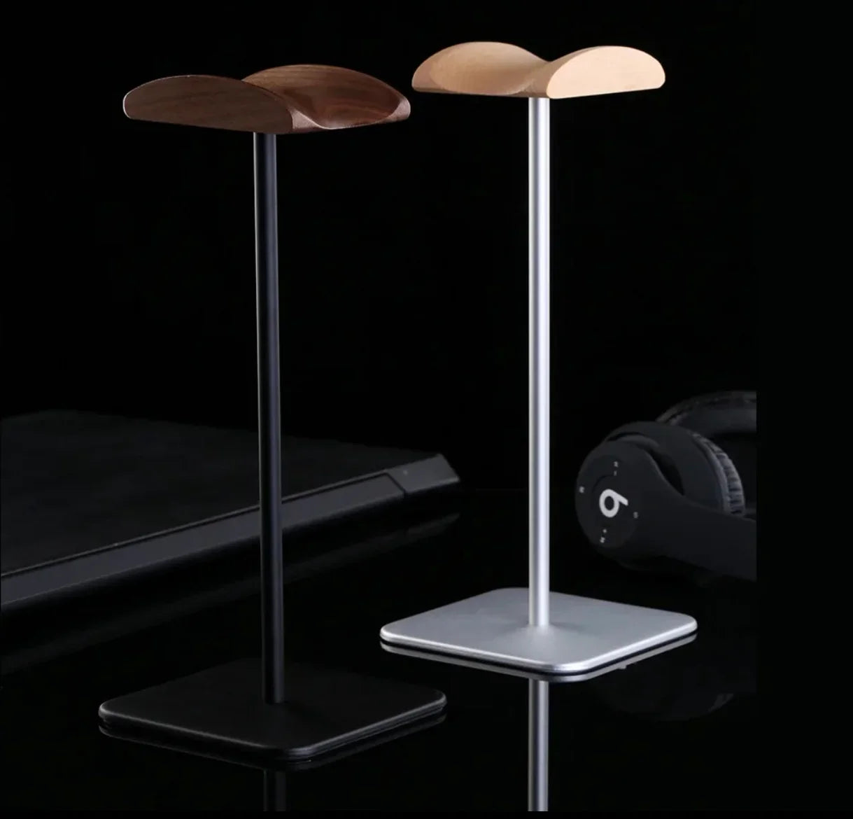 Sleek wooden headphone stands with black and silver bases for desk organization