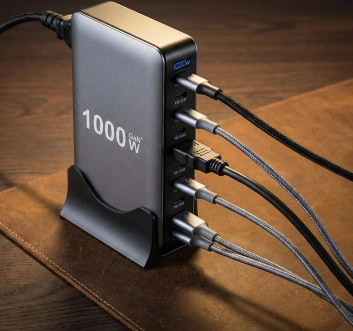 1000W GaN fast charging hub with multiple devices connected, on wooden desk