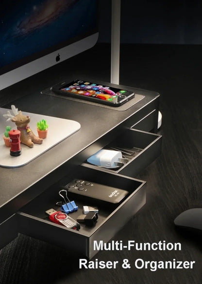 Desk organizer riser with drawers holding office accessories, phone, and computer monitor