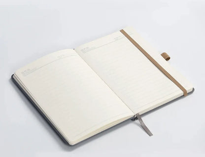 Open lined notebook with elastic band and pen holder on white background