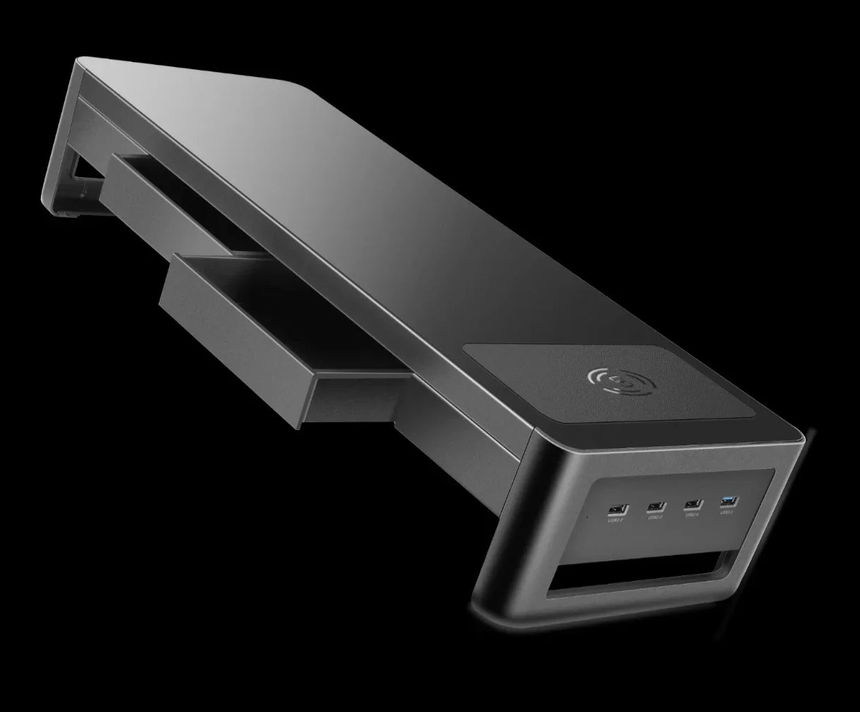 Black monitor stand with USB ports, wireless charging pad, and side storage drawer
