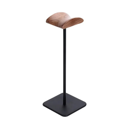 Minimalist wooden and metal headphone stand with square black base on white background