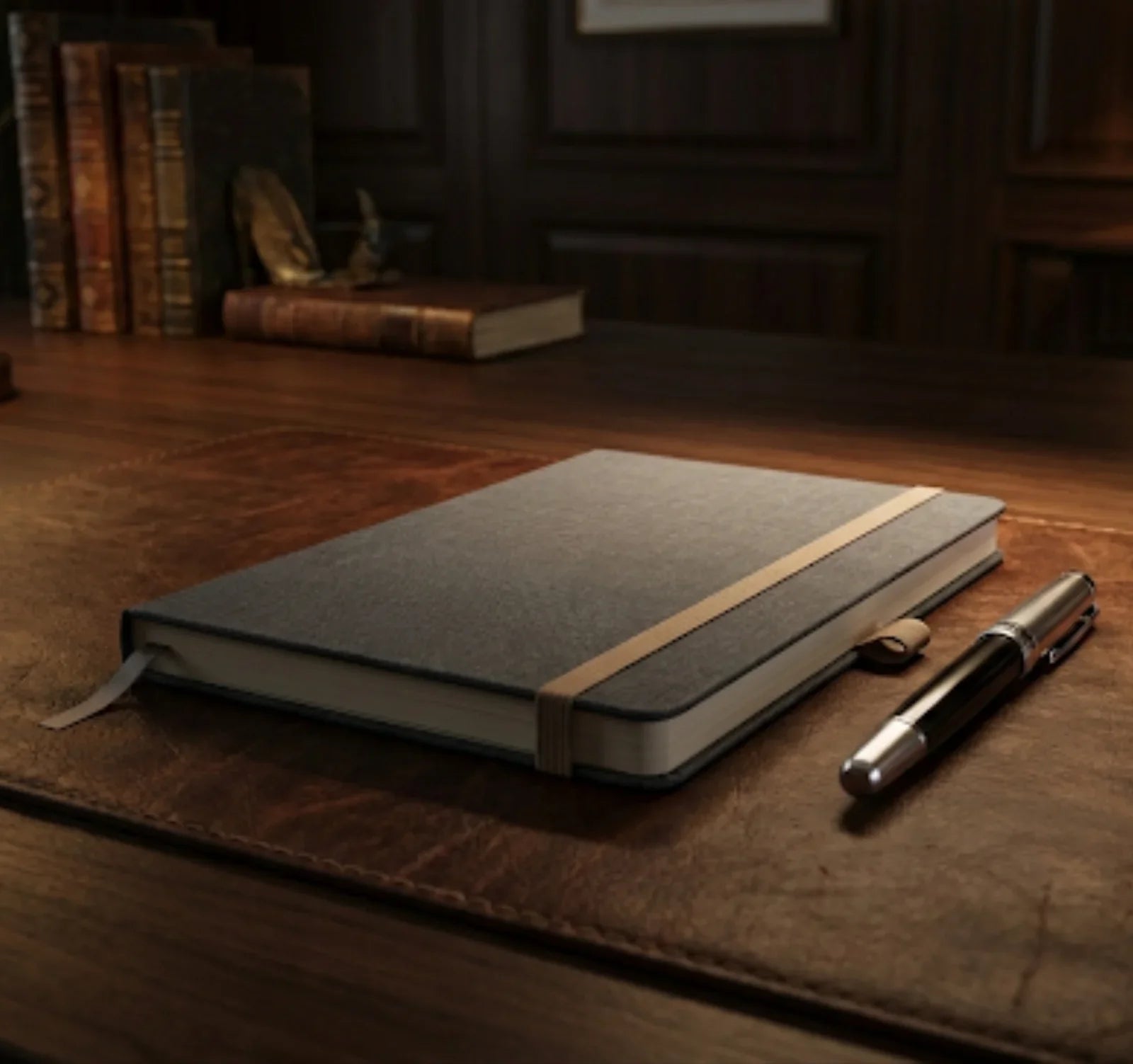 Elegant notebook with elastic band and pen on a leather desk in a classic office setting