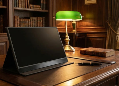 Modern tablet on wooden desk with pen, vintage lamp, and books in classic office setting