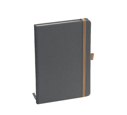 Gray hardcover notebook with elastic band and pen holder, standing upright on white background